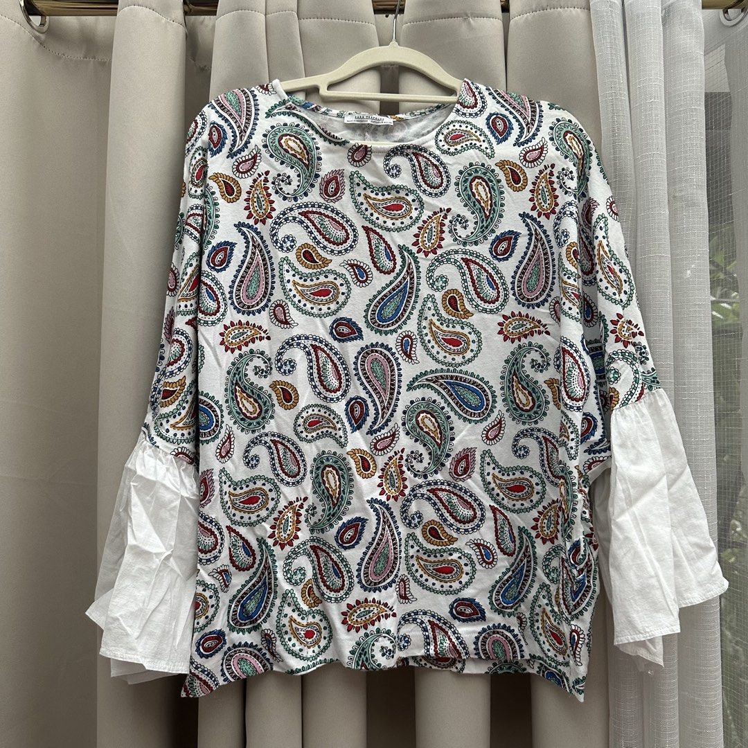 Zara Paisley Ruffle Cotton Top (Category: Blouses) located in Cainta. Submitted by tooonico (Listing ID 1460382458, Image 1). Description: Fits up to M, Beautiful print and so flattering! RFS: Decluttering MOP: GCash/Maya/Maribank/UB .