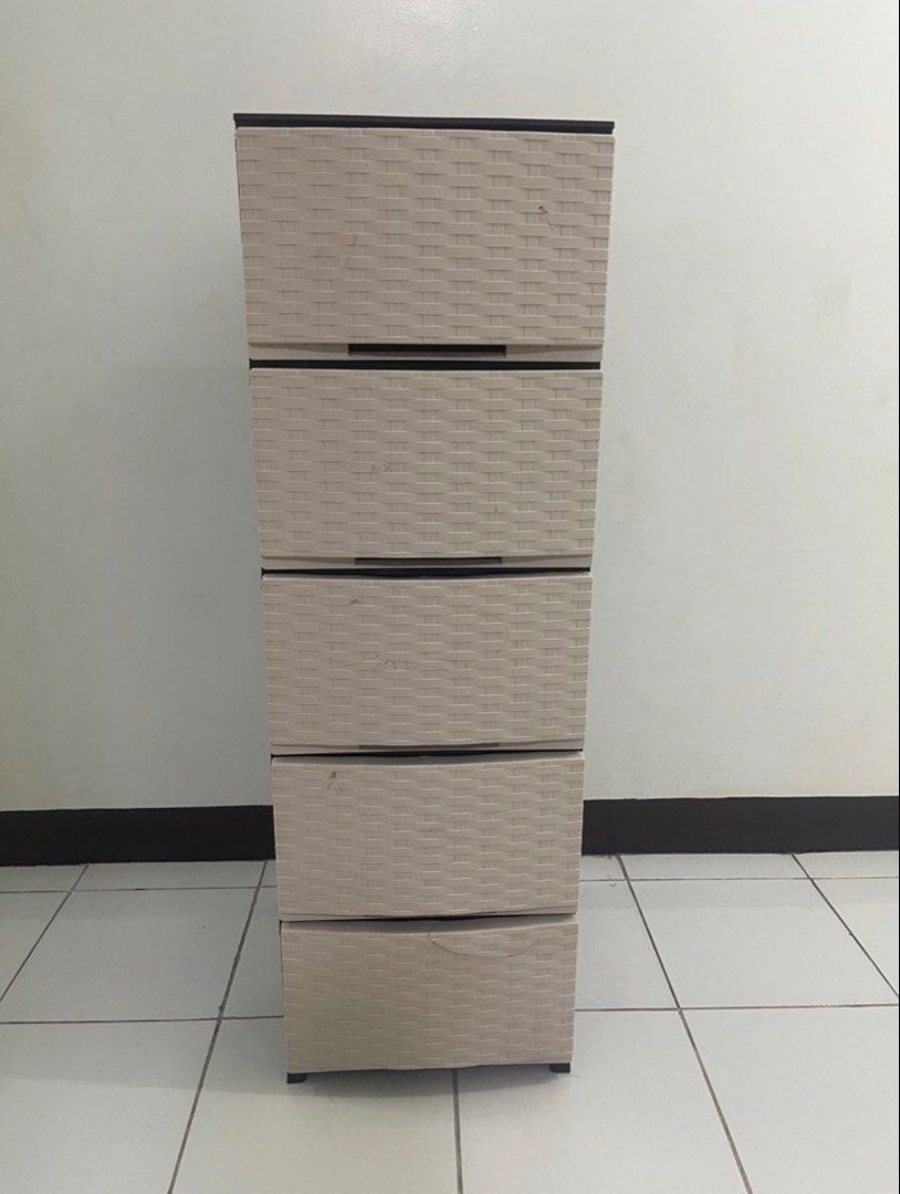 5-Drawer Woven Plastic Storage Cabinet (Category: Shelves, Cabinets & Racks) located in Cavite. Submitted by mayannemalunes (Listing ID 1460651437, Image 1). Description: - Light beige 5-drawer storage cabinet - Features a stylish woven texture - Ideal for organizing clothes, linens, or other household items - Minor cosmetic cracks on the top drawer (as pictured), does not affect functionality - Sturdy and functional construction - Approximate Di