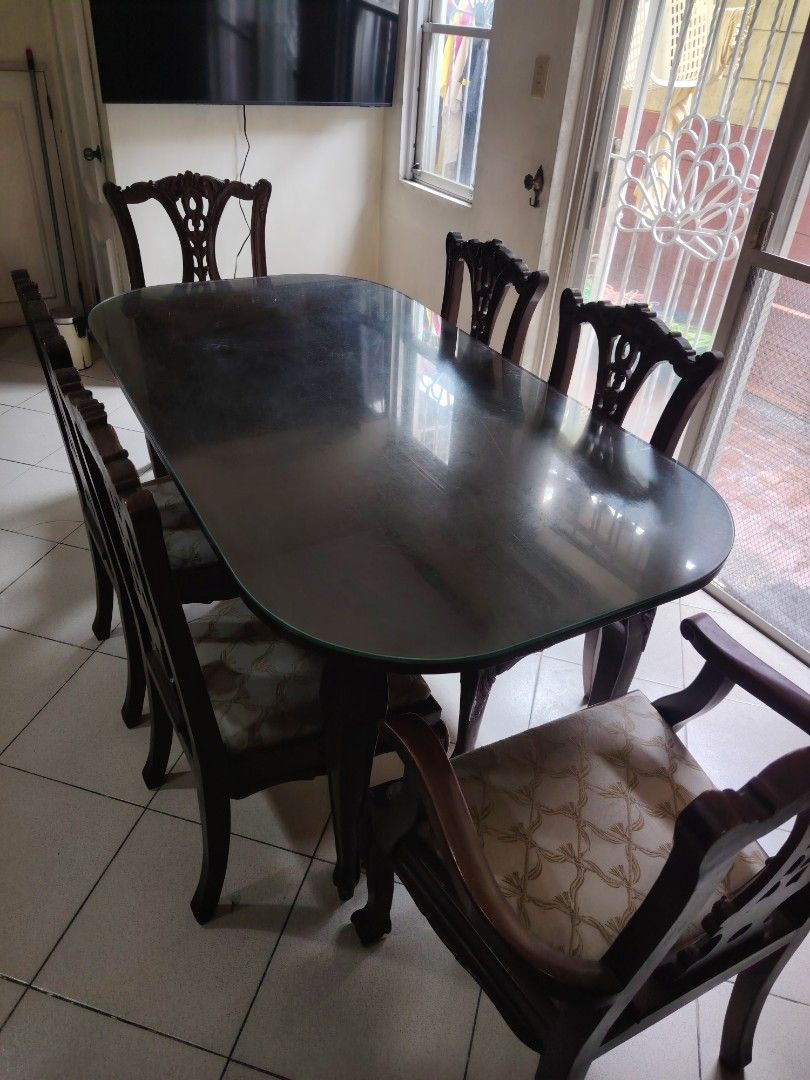 6 seater Narra Dining Table with Glass Top (Category: Tables & Sets) located in Antipolo. Submitted by roelbalingit (Listing ID 1460527173, Image 2). Description: - Oval wooden dining table with a sleek glass top L: 69 inches, W: 36 inches, H: 31 inches) - Includes 6 Victorian style chairs (including 2 cabisera with arms) .