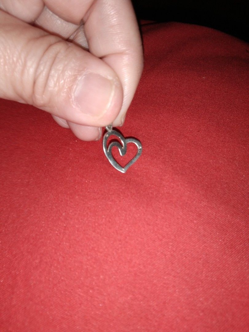 925 Silver Heart Pendant with Diamonds (Category: Necklaces) located in Quezon City. Submitted by eidorableshop (Listing ID 1460577949, Image 2). Description: - Cute double heart pendant - Silver tone finish - One heart features small embedded diamonds - Lightweight and delicate design - Ideal for everyday wear or special occasions - Easily attaches to any necklace chain.