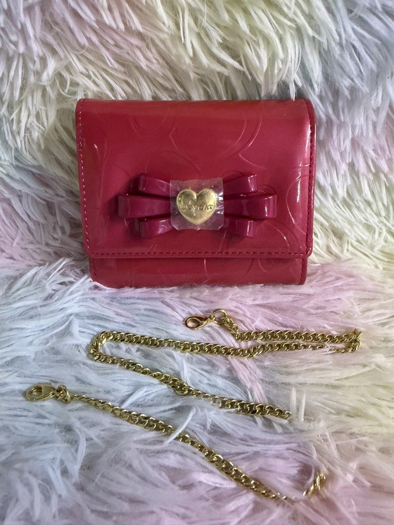 ✨ LOVCAT PARIS Patent Leather Wallet with Chain Strap (Category: Luxury Bags & Wallets) located in Rizal. Submitted by affordabagz (Listing ID 1460654916, Image 1). Description: 📌 DETAILS: • Brand: LOVCAT PARIS 🇫🇷 • Color: Vibrant Red / Fuchsia Glossy Patent Leather • Material: Patent leather with embossed heart-logo pattern • Design: Signature bow + gold heart emblem, detachable gold chain strap → wallet + crossbody pouch 2-in-1 • Interior: P
