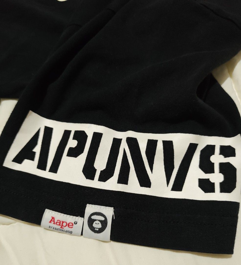 AAPE By A Bathing Ape Skull Cross Bone Tee (Category: Tshirts & Polo Shirts ) located in Tanay. Submitted by grkfellasthriftcollection (Listing ID 1460712268, Image 3). Description: width 22 in length 29 in Xl on tag (Best fits to large) Very Good Condition Color may vary due to lighting .