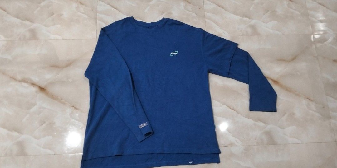 Ader Error Blue Crewneck (Category: Luxury Apparel) located in Rizal, Mindoro Occidental. Submitted by thrift.finds_5103 (Listing ID 1460612920, Image 1). Description: This is an Ader Error blue 2020 Spring/Summer long-sleeve graphic t-shirt featuring a chest logo print and layered sleeve detail. Dimes: 26x 30 Location: Occidental Mindoro South Luzon Philippines 5103.