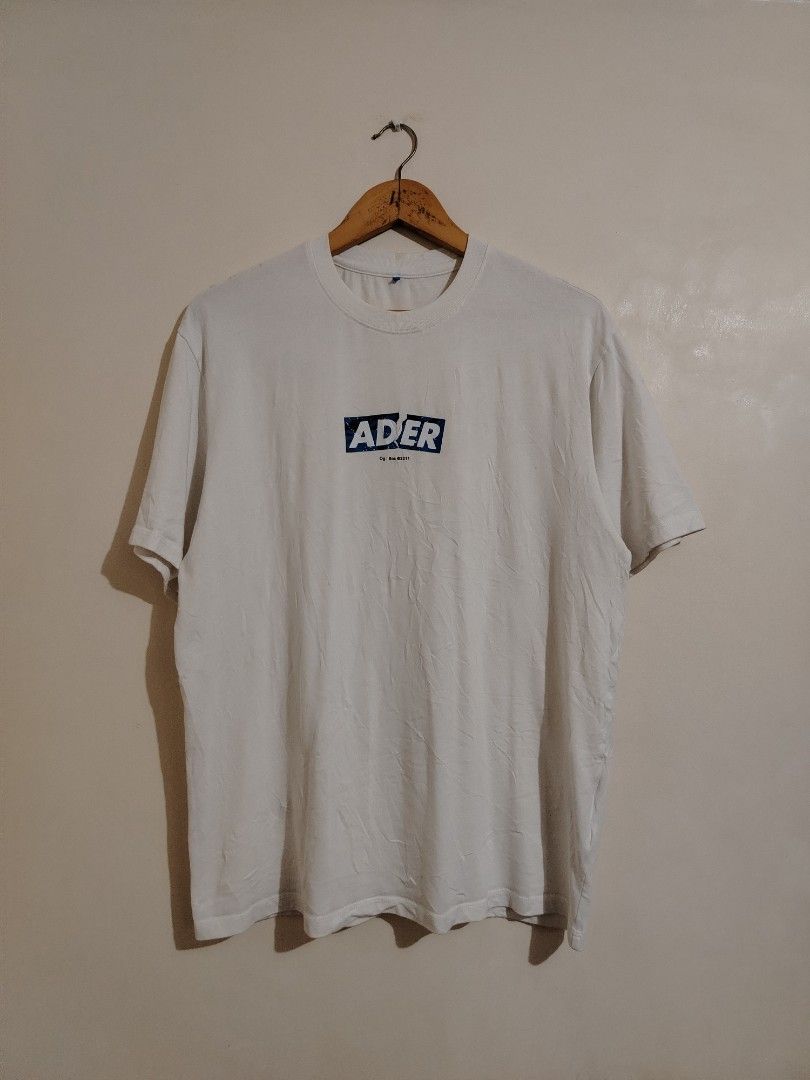 ADER Error White T-Shirt with Blue Graphic Logo (Category: Tshirts & Polo Shirts ) located in Cavite. Submitted by koyawell.ph (Listing ID 1460665351, Image 1). Description: - Authentic ADER Error white t-shirt - Features signature blue graphic logo on the front - Made from 100% premium cotton - Ideal for comfortable everyday styling - Large 21 x 27 dimensions - Please check all photos for condition and details.