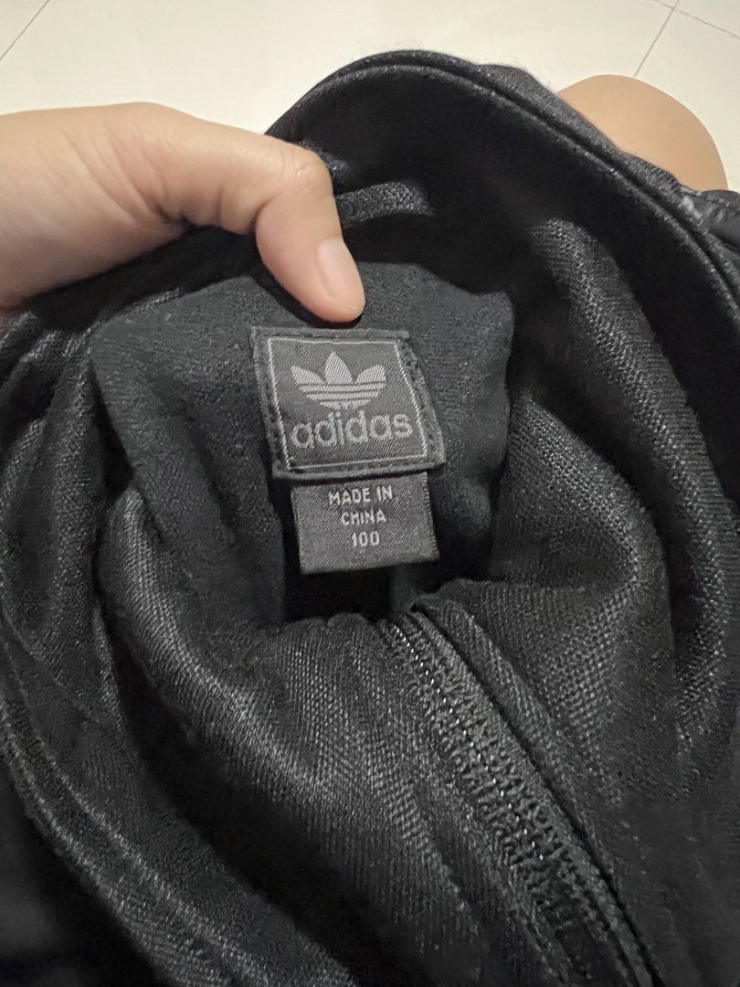 Adidas Black Shiny Puffer Track Jacket (Category: Coats, Jackets and Outerwear) located in Lapu Lapu. Submitted by chelon.865 (Listing ID 1460700654, Image 3). Description: - Black Adidas track jacket - Shiny puffer front with black sleeves and collar - Full zip closure - Adidas logo on zipper pull and inside tag - Made in China - Size 100 - Perfect for casual wear or sports.