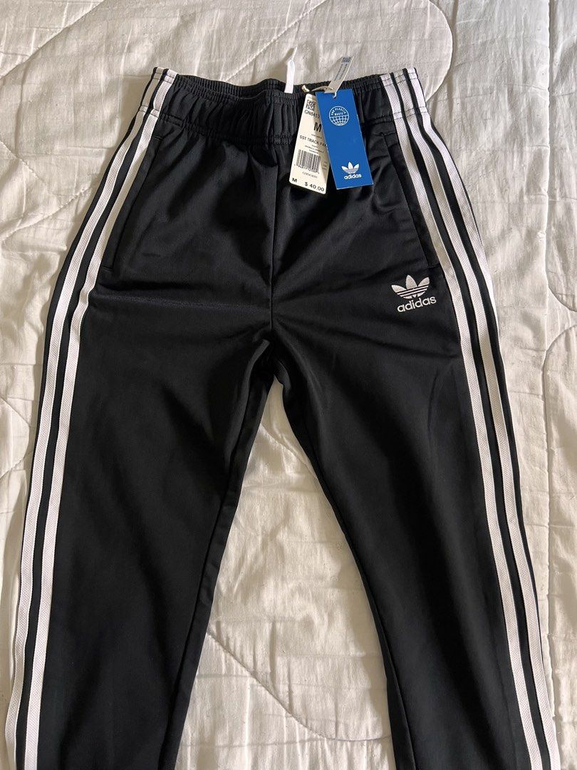 Adidas Black Striped Track Pants (Category: Other Bottoms) located in Taguig. Submitted by gingerderp (Listing ID 1460571255, Image 1). Description: Never worn Adidas track pants that are so comfortable and versatile! Can easily give you a sporty look!.
