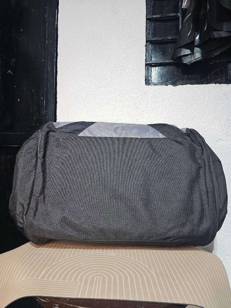 Adidas Duffle Bag (Category: Luxury Bags & Wallets) located in Baguio. Submitted by kayeonlineshop (Listing ID 1460575922, Image 2). Description: Vintage/Y2K-era adidas gym and athletic duffel bag. It features a classic two-tone medium grey and black design crafted from heavy-duty nylon or polyester fabric built to handle sports and travel. Measurements L-27cm W-54cm.