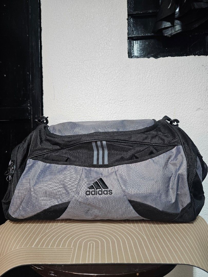Adidas Duffle Bag (Category: Luxury Bags & Wallets) located in Baguio. Submitted by kayeonlineshop (Listing ID 1460575922, Image 1). Description: Vintage/Y2K-era adidas gym and athletic duffel bag. It features a classic two-tone medium grey and black design crafted from heavy-duty nylon or polyester fabric built to handle sports and travel. Measurements L-27cm W-54cm.