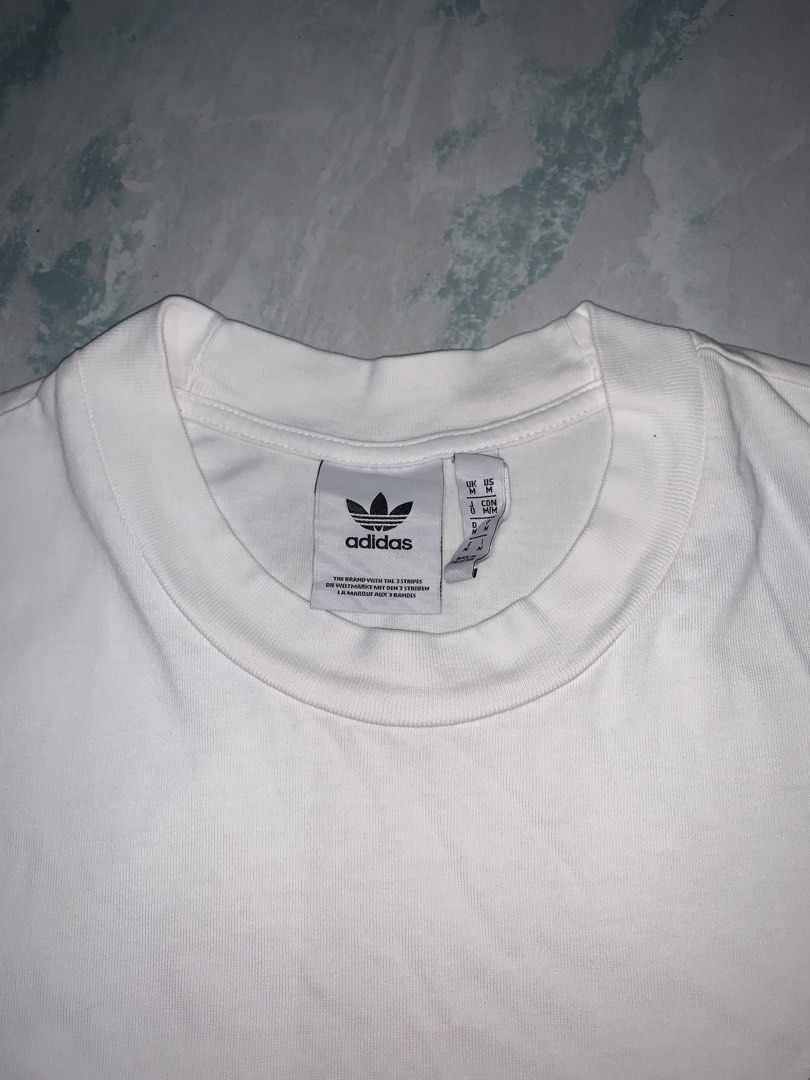 Adidas embroidered tee (Category: Tshirts & Polo Shirts ) located in Pasig City. Submitted by thriftnflip1600 (Listing ID 1460546366, Image 3). Description: M on tag Width: 21” Length: 30” Color rate: 9+/10 Condition: 9+/10 No issues.