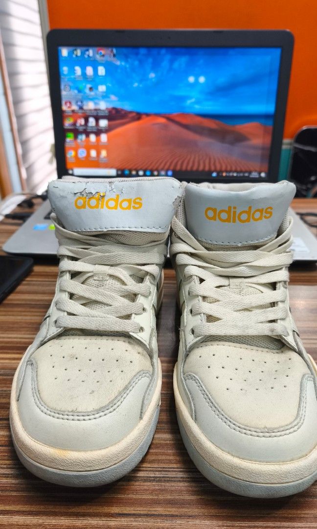Adidas High Top Sneakers Cream (Category: Sneakers) located in Caloocan City. Submitted by majehjembo8 (Listing ID 1460555625, Image 2). Description: - Cream Adidas high top sneakers - Classic three-stripe design - Laces show some wear - Minor scuffing on toe and sides - Adidas logo on tongue is slightly faded - Perfect for everyday casual wear.