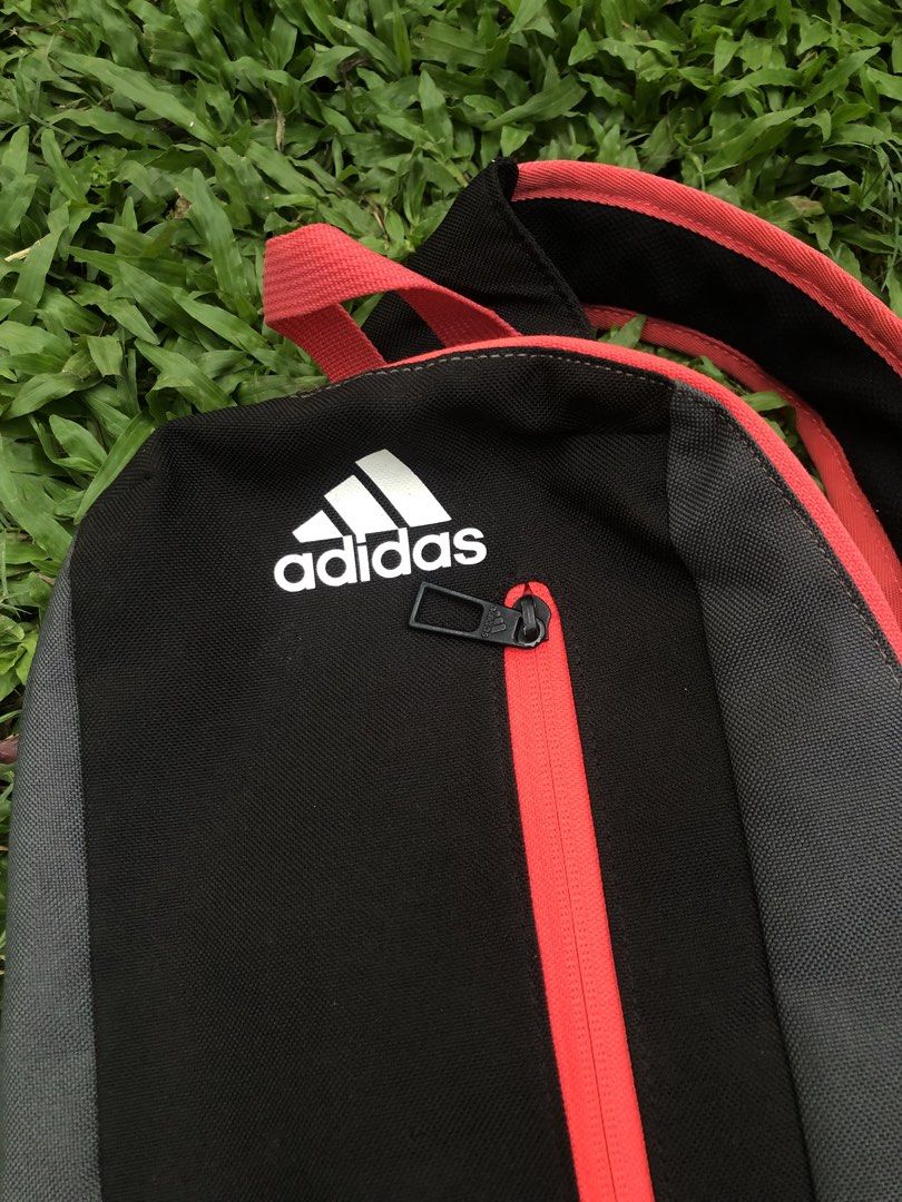 Adidas Mini Black Red Grey Sling Bag (Category: Backpacks) located in Kabasalan. Submitted by hamugaway (Listing ID 1460521953, Image 2). Description: - Adidas mini backpack - Color: Black with grey panels and red accents - Features a front zip pocket - Bright orange interior lining - Made in Vietnam - Ideal for carrying your essentials.