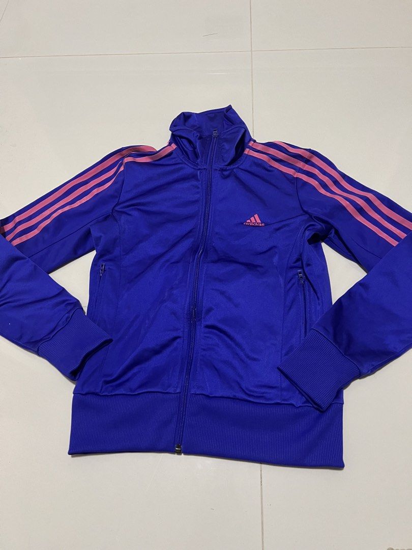 Adidas Track Jacket Blue Pink Stripes (Category: Coats, Jackets and Outerwear) located in Lapu Lapu. Submitted by chelon.865 (Listing ID 1460700902, Image 1). Description: - Blue Adidas track jacket - Size: 095 - Pink stripes on sleeves - Full zip front - Pockets included - Ribbed cuffs and hem - Made in China.