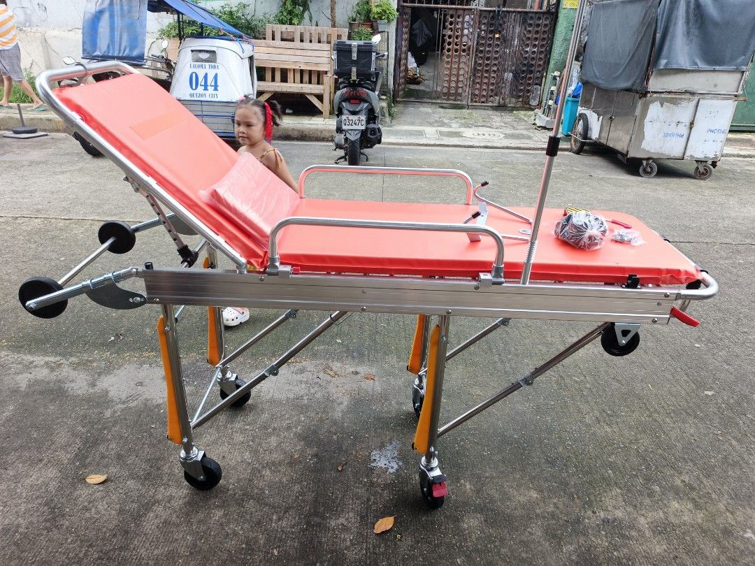 Adjustable Medical Stretcher with Wheels (Category: Announcements) located in Quezon City. Submitted by baborjerry58098 (Listing ID 1460580511, Image 1). Description: - Adjustable medical stretcher - Bright orange padding for visibility - Wheels for easy transport - Backrest adjustable to multiple heights - Includes IV pole - Comes with restraints - Perfect for clinics or home use - Ready for immediate pickup.