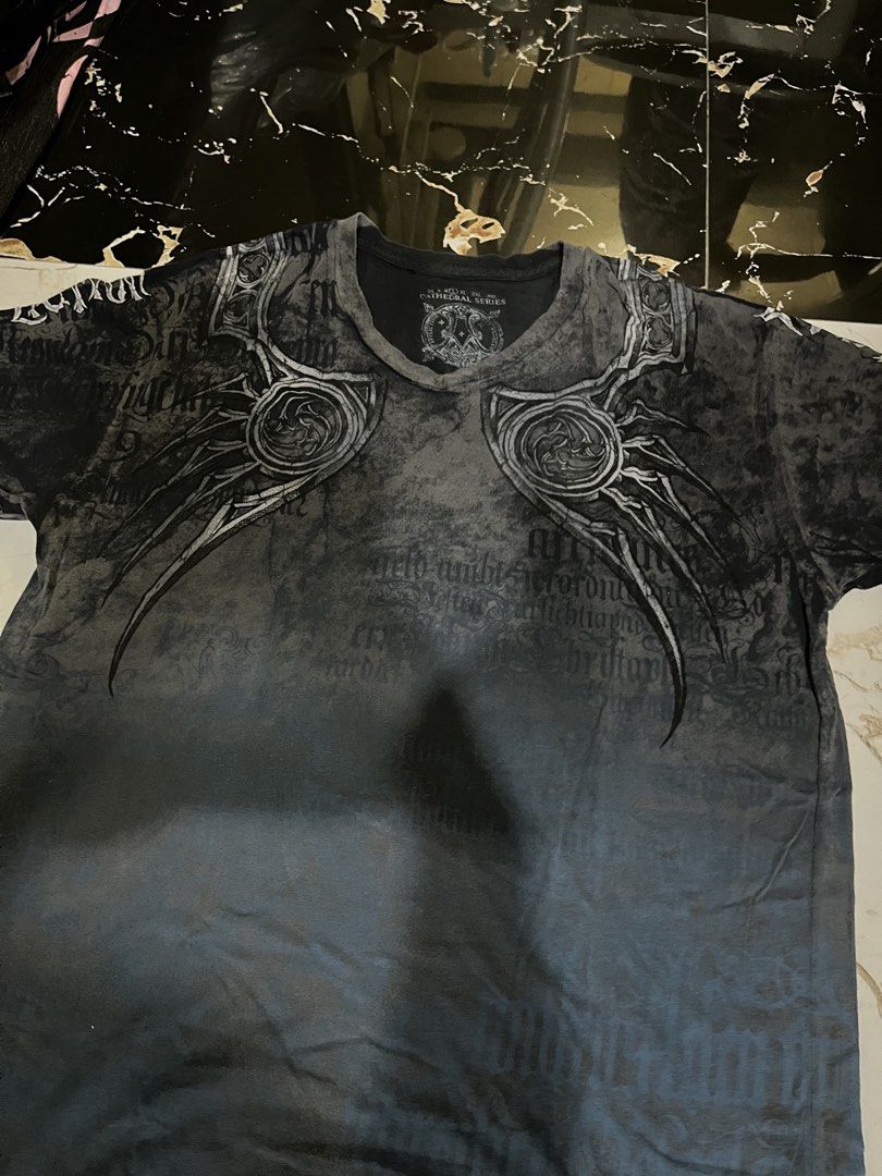 Affliction Cathedral Series T-Shirt (Category: Tshirts & Polo Shirts ) located in Caloocan City. Submitted by einsteinmi44496 (Listing ID 1460619314, Image 2). Description: - Affliction Cathedral Series T-Shirt - Striking front and back graphic print - Size: e20x29 - Made in USA - Material: 100% Cotton.