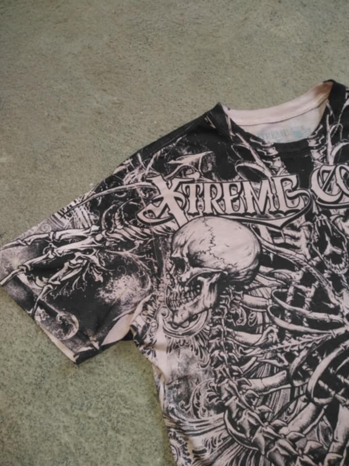 Affliction Hoodie & Graphic Tees Bundle (Category: Activewear) located in Manila. Submitted by freewater.c3e489 (Listing ID 1460714069, Image 3). Description: - Bundle includes 3 graphic apparel items. - Affliction hoodie with skull and crossbones graphic. - Graphic t-shirt with full skeleton print. - Graphic t-shirt with heart and guns design..