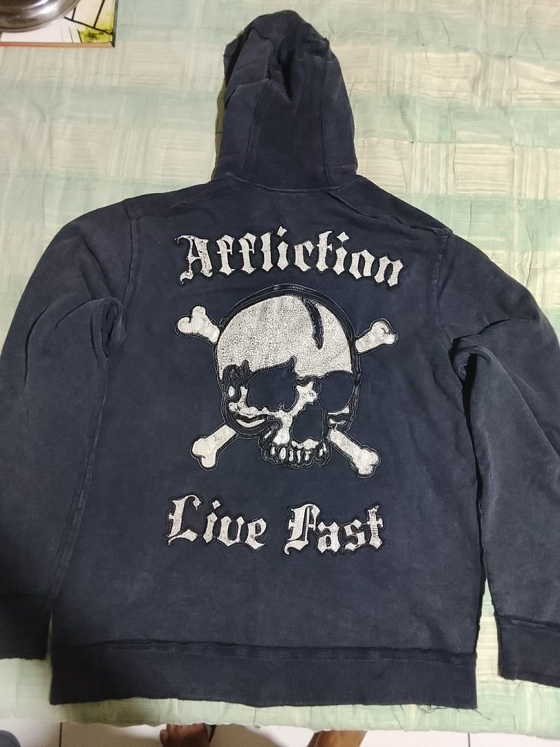 Affliction Hoodie & Graphic Tees Bundle (Category: Activewear) located in Manila. Submitted by freewater.c3e489 (Listing ID 1460714069, Image 2). Description: - Bundle includes 3 graphic apparel items. - Affliction hoodie with skull and crossbones graphic. - Graphic t-shirt with full skeleton print. - Graphic t-shirt with heart and guns design..