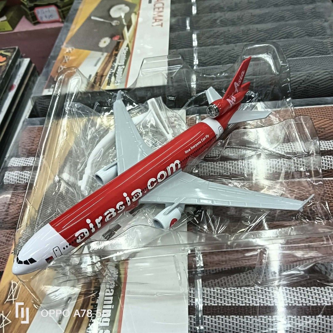 AirAsia Airplane Model Toy (Category: Vehicle & Diecast Models) located in Manila. Submitted by iliasjen3082126 (Listing ID 1460568895, Image 1). Description: - Die-cast AirAsia airplane model - Iconic red and white livery with 'airasia.com' branding - Brand new in original plastic packaging - Approximately 15cm in length - Ideal for collectors or display.