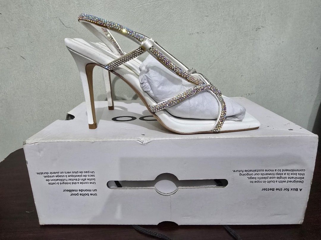 ALDO White Embellished Heeled Sandals (Category: Heels) located in Marikina City. Submitted by bloomsandgreenscollection (Listing ID 1460679596, Image 3). Description: - Brand: ALDO - Size: 5.5 to 6 - Color: White - Style: Heeled Sandals - Features: Rhinestone-decorated straps, Square toe - Condition: Comes with original box - Occasion: Ideal for dressing up outfits.
