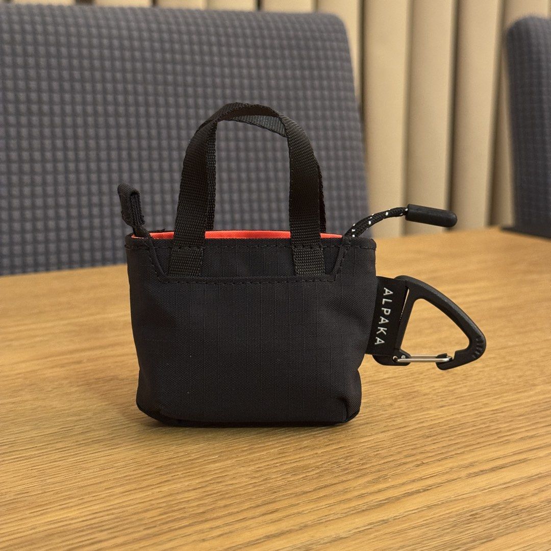Alpaka Micro Tote (Category: Tote Bags) located in Pasig City. Submitted by mon.alcantara (Listing ID 1460653581, Image 2). Description: There are 2 pieces available at Php1,000 each. Retail price is at Php1,495 AirPods in photo for size reference only. Key Features • 1 zipper pocket (Fits AirPods Pro) • O-ring clip to attach to bags or lanyard • Adjustable nylon lanyard Materials EXTERIOR • Axoflux 210D ripstop nylon in black INTERIOR • Axoflux 