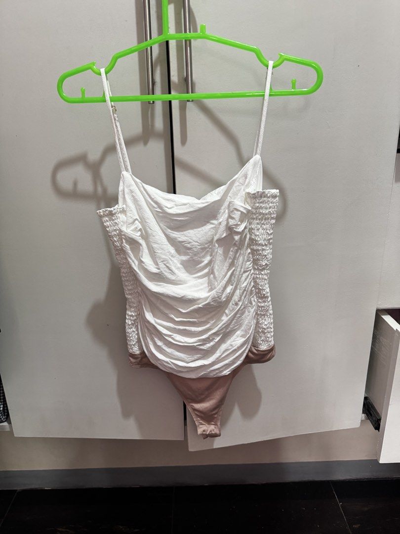 Amanda Uprichard White Ruched Bodysuit Size S (Category: Others Tops) located in Rosales. Submitted by thriftingismygame (Listing ID 1460536153, Image 1). Description: - White ruched bodysuit by Amanda Uprichard - Features smocked sides and adjustable straps - Nude-colored thong style bottom - Made from a linen and rayon blend - Versatile for dressing up or down - Size: Small (S).