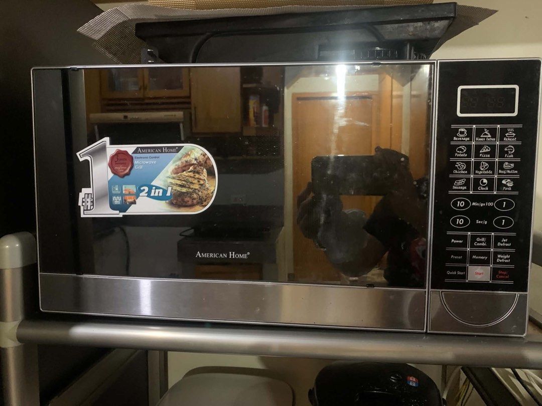 American Home 2-in-1 Microwave Grill (Category: Ovens & Toasters) located in Paranaque City. Submitted by declutterby4angels (Listing ID 1460540100, Image 1). Description: - American Home Microwave with Grill Function - 2-in-1 Electronic Control Model - Convenient Cooking Presets (Potato, Pizza, Chicken, etc.) - Built-in Clock and Timer Functions - Ideal for Quick Meals and Grilling.