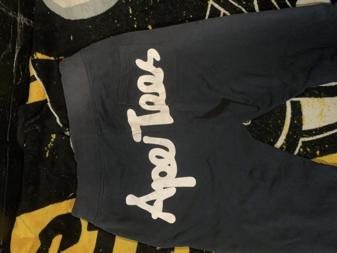 Ape Tees by Jim Design Sweatpants (Category: Joggers) located in San Carlos. Submitted by jemercagui42788 (Listing ID 1460591113, Image 3). Description: - Brand: Ape Tees by Jim Design - Color: Black - Size: M - Features: Ape graphic on left thigh, large Ape Tees lettering on back, drawstring waist with branded tips, striped detail on right leg..
