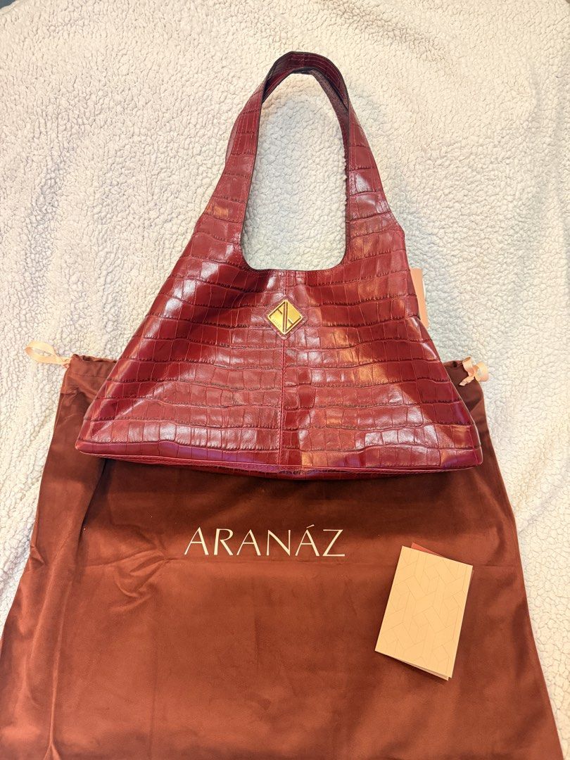 ARANAZ Red Croc Sando Tote medium (Category: Shoulder Bags) located in Manila. Submitted by danihorv123 (Listing ID 1460706079, Image 2). Description: - Beautiful red shoulder bag - Chic croc-embossed finish - Elegant gold-tone diamond logo on the front - Comes with original ARANAZ dust bag - Includes a small booklet - Adds a touch of sophistication to any outfit also amazing work bag fits 15 inch laptop.