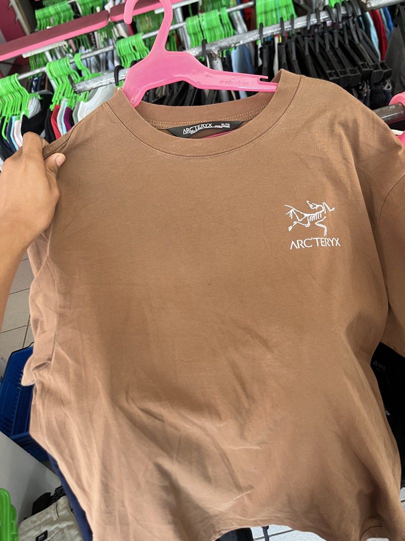 Arc'teryx Training Division T-Shirt - Brown (Category: Tshirts & Polo Shirts ) located in Lapu Lapu. Submitted by vanzfinds_16 (Listing ID 1460597927, Image 1). Description: - Brown Arc'teryx t-shirt - Features Arc'teryx logo on the front - Back graphic: World map with 'Training Division' and 'Stop War Stop Racism' text - Made from comfortable material - Perfect for casual wear.