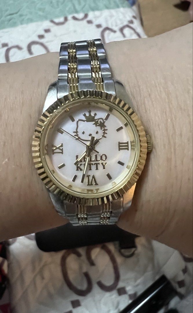 Authenthc Hello Kitty Watch Two-Tone Stainless Steel (Category: Women's Watches) located in Quezon City. Submitted by letsdeclutter101 (Listing ID 1460630393, Image 1). Description: - Adorable Kitty watch - bought in Sanrio Purolando tokyo japan - Two-tone stainless steel band with elegant gold accents - Classic white dial featuring Roman numerals - Charming Kitty graphic on the dial - Adjustable band for a comfortable fit - Ideal gift for Kitty 
