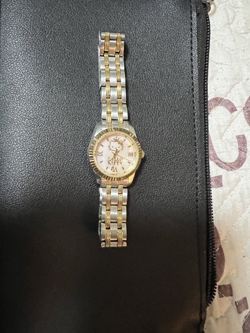 Authenthc Hello Kitty Watch Two-Tone Stainless Steel (Category: Women's Watches) located in Quezon City. Submitted by letsdeclutter101 (Listing ID 1460630393, Image 2). Description: - Adorable Kitty watch - bought in Sanrio Purolando tokyo japan - Two-tone stainless steel band with elegant gold accents - Classic white dial featuring Roman numerals - Charming Kitty graphic on the dial - Adjustable band for a comfortable fit - Ideal gift for Kitty 