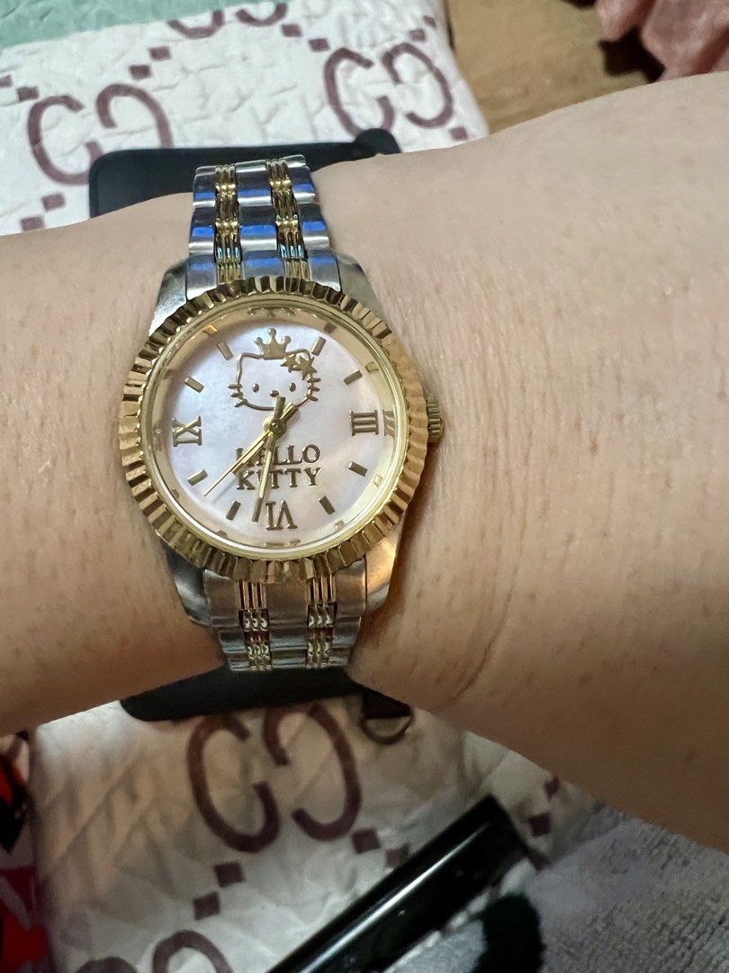 Authenthc Hello Kitty Watch Two-Tone Stainless Steel (Category: Women's Watches) located in Quezon City. Submitted by letsdeclutter101 (Listing ID 1460630393, Image 3). Description: - Adorable Kitty watch - bought in Sanrio Purolando tokyo japan - Two-tone stainless steel band with elegant gold accents - Classic white dial featuring Roman numerals - Charming Kitty graphic on the dial - Adjustable band for a comfortable fit - Ideal gift for Kitty 