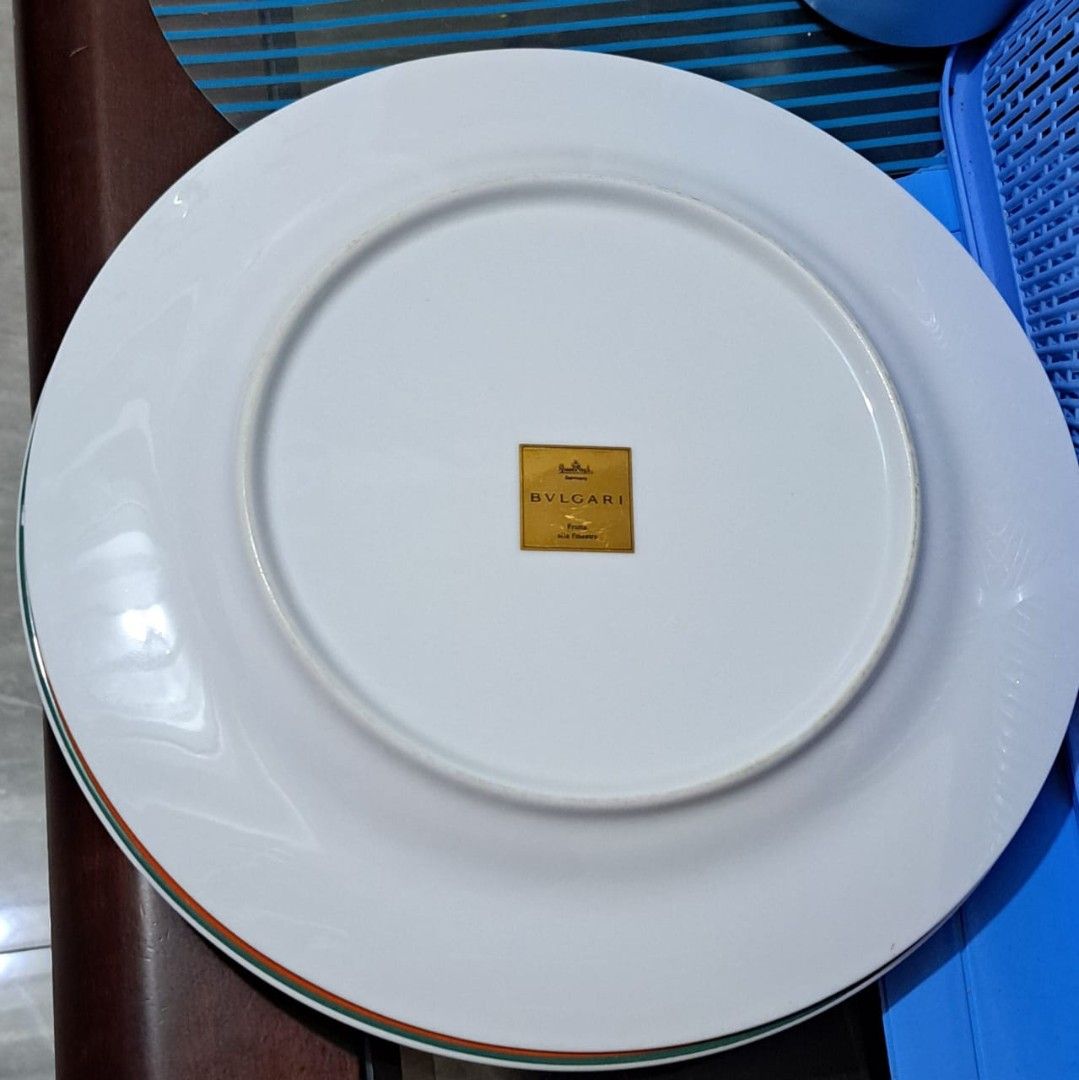 Authentic BVLGARI Porcelain Dinner Plate (Category: Luxury Accessories) located in Bulacan. Submitted by tripledouble532 (Listing ID 1460598736, Image 2). Description: Brand: BVLGARI (Bulgari) Material: Porcelain Country mark: France Design: White porcelain with a thin orange and green double rim Type: Bulgari branded tableware/dinner plate The gold square BVLGARI mark on the underside is an important feature for identification. Bulgari has produ