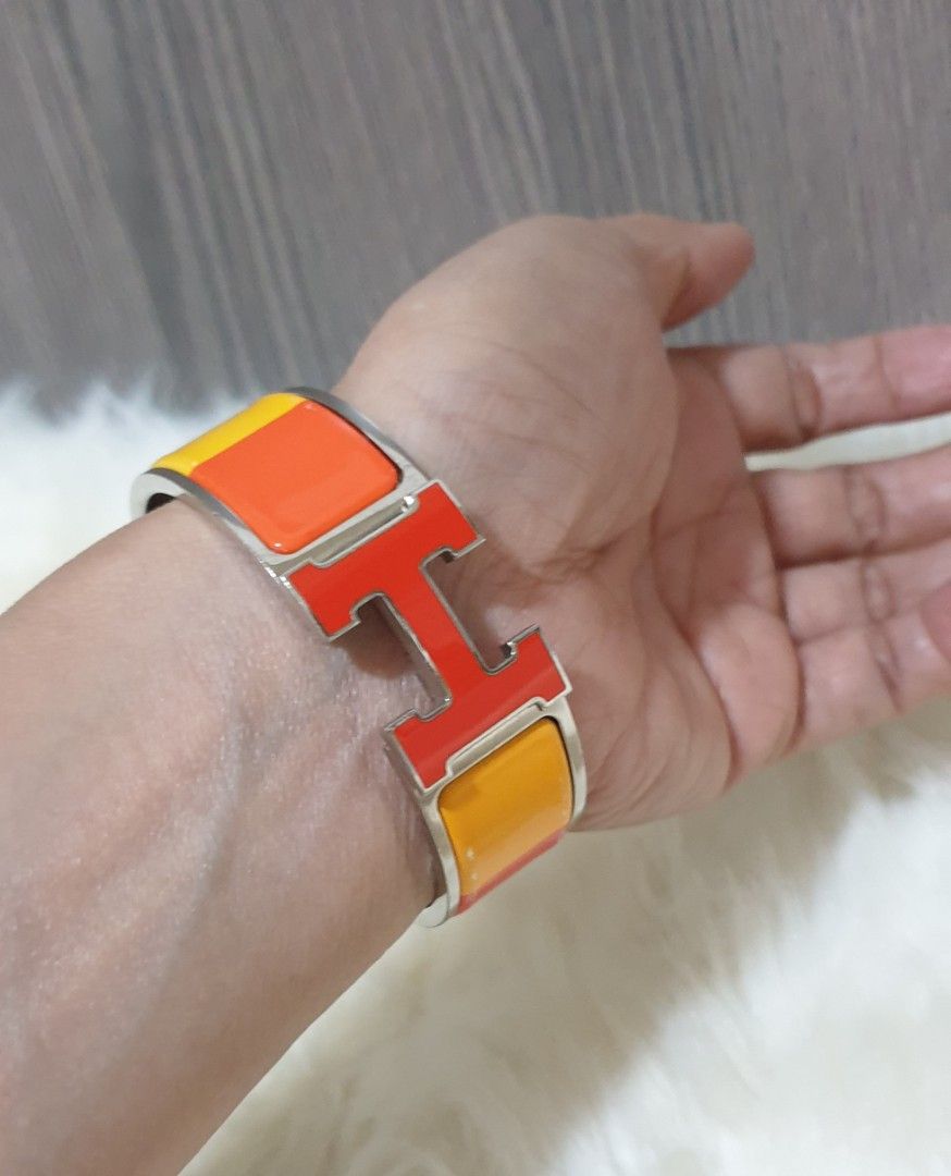 Authentic Hermes Clic Clac Rainbow (Category: Luxury Accessories) located in Pasig City. Submitted by castlescollections (Listing ID 1460618279, Image 1). Description: Guaranteed Authentic a Hermes Clic Clac Rainbow Orange in good condition.