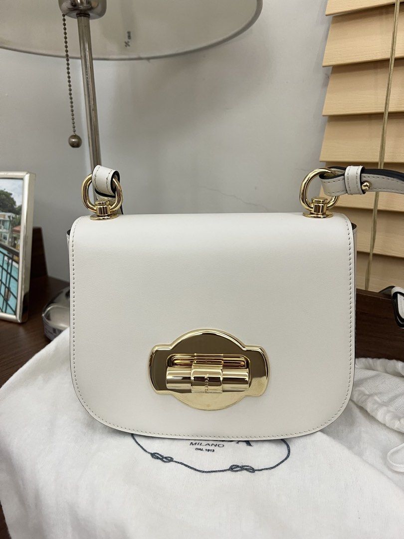 Authentic preloved Prada 1BD239 White leather crossbody bag (Category: Luxury Bags & Wallets) located in San Pablo. Submitted by misskittyph (Listing ID 1460527634, Image 2). Description: Prada 1BD239 White leather saddle crossbody bag ▪️55k only ✨✨Chic, sleek, and effortlessly elegant – the Small White Prada Saddle Crossbody with gold-tone hardware and twist lock adds a touch of luxury to every outfit ✨ . 64% off retail price approx 155k 9/10 co