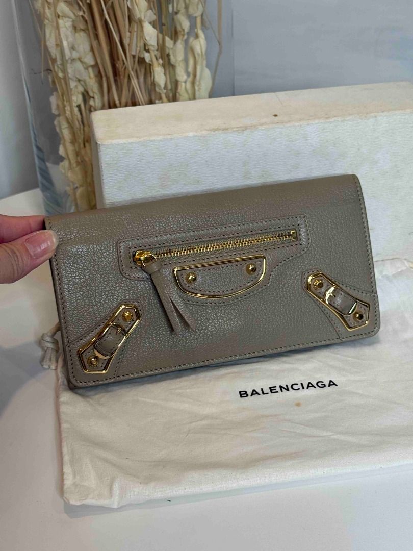 Balenciaga Grey Leather Zip Around Wallet (Category: Luxury Bags & Wallets) located in Las Pinas. Submitted by happystar_cac724 (Listing ID 1460600788, Image 1). Description: - Authentic Balenciaga wallet in stylish grey leather. - Elegant gold hardware accents. - Secure zip-around closure. - Interior features multiple card slots and compartments for excellent organization. - Comes with original dust bag. - Perfect for keeping your essentials tid