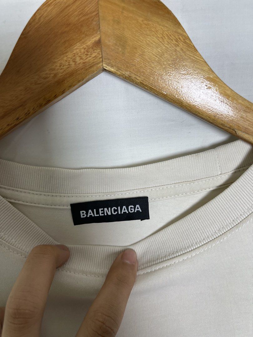 Balenciaga Logo T-Shirt (Category: Tshirts & Polo Shirts ) located in Manila. Submitted by noahcastilljos363 (Listing ID 1460557930, Image 3). Description: - Brand: Balenciaga - Color: Light Beige - Size: M - Material: Good quality cotton - Features: Balenciaga logo on front left chest, larger logo across the back - Style: Great for casual wear.