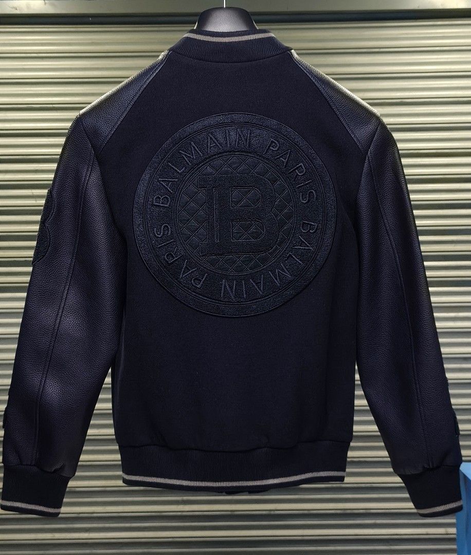 Balmain Paris Limited Edition Navy Bomber Jacket (Category: Coats, Jackets and Outerwear) located in Zamboanga. Submitted by benbryanab14320 (Listing ID 1460657992, Image 2). Description: - Authentic Navy Balmain Paris Bomber Jacket - Premium Leather Sleeves and Details - Iconic Balmain 'B' Logo on Chest - Large Embossed Balmain Logo on Back - "Balmain Paris" Text Branding on Front and Sleeve - Comes with Original Tags and Garment Bag - Size: 46 