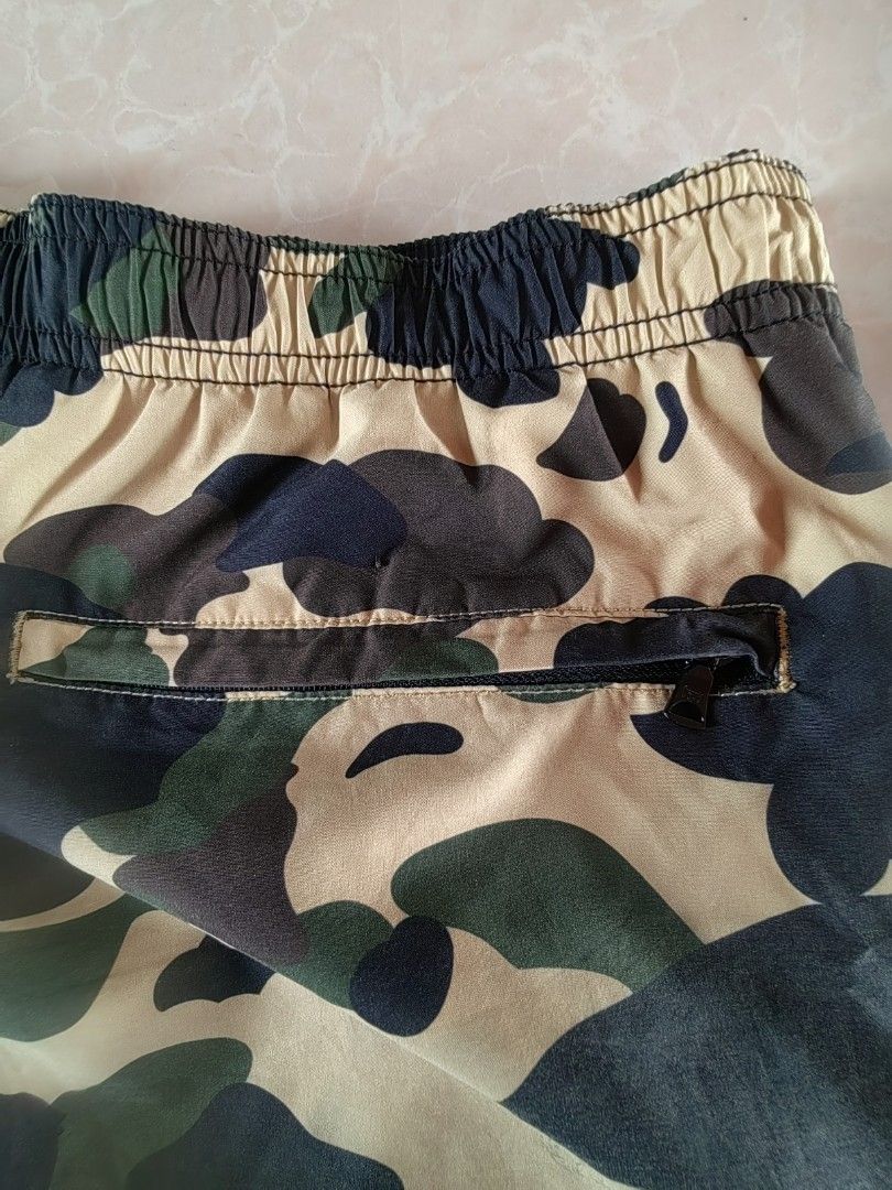BAPE Camo Split Shorts Black (Category: Shorts) located in Caloocan City. Submitted by dilenb (Listing ID 1460532765, Image 2). Description: - BAPE split design shorts - Classic camo print on one side, solid black on the other - Comfortable elastic waistband with adjustable drawstring - Convenient zippered pocket on the back - Signature BAPE logo tag on the side - Ideal for everyday casual wear.