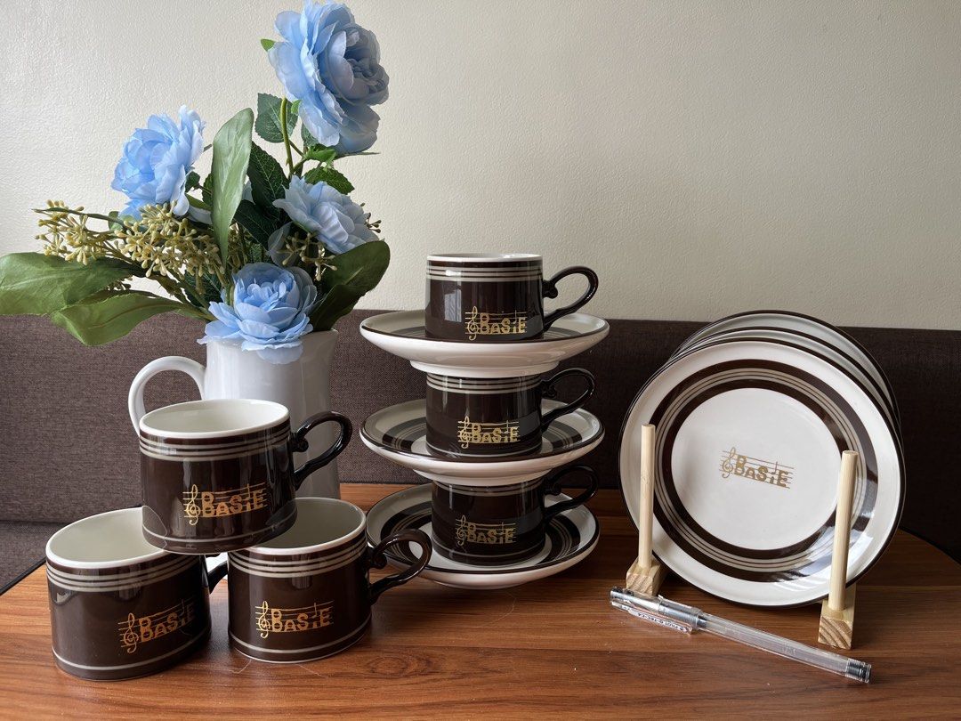 Basie Coffee Cup Saucer Set and Plates (Category: Coffee & Tea Tableware) located in Caloocan City. Submitted by happypenguin-808164 (Listing ID 1460526689, Image 1). Description: - Set includes 4 brown and white coffee cups. - Comes with 4 matching saucers. - Also includes a stack of 5 plates. - All pieces feature a charming gold musical note and 'Basie' logo. - Ideal for enjoying your favorite coffee or tea. - Adds a touch of classic elegance t