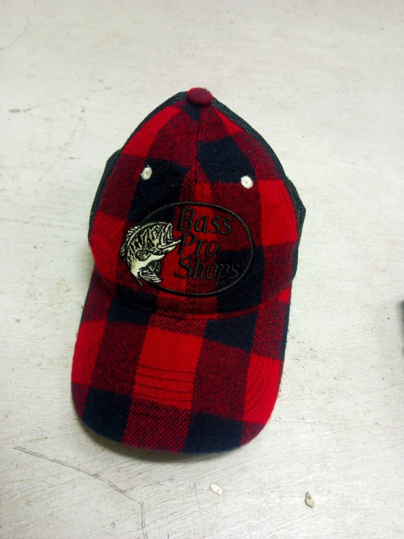 Bass Pro Shops Red Black Plaid Baseball Cap (Category: Caps & Hats) located in San Carlos. Submitted by jemercagui42788 (Listing ID 1460593657, Image 1). Description: - Classic red and black plaid baseball cap - Brand: Bass Pro Shops - Features iconic fish logo embroidered on the front - Adjustable strap at the back for a custom fit - Ideal for outdoor activities, sunny days, or a vintage casual look.
