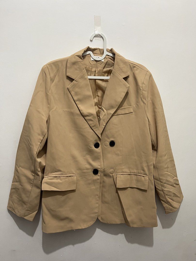 Beige Double-Breasted Blazer (Category: Coats, Jackets and Outerwear) located in Manila. Submitted by jonalainea95245 (Listing ID 1460708016, Image 1). Description: - Classic beige blazer - Double-breasted style with two black buttons - Two flap pockets at the front - Fully lined interior Location: Malabon RFS: decluttering.