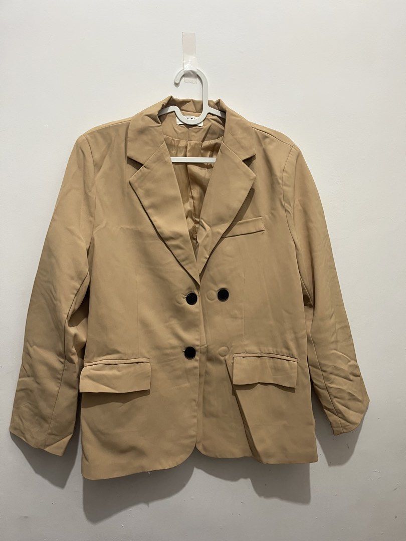 Beige Double-Breasted Blazer (Category: Coats, Jackets and Outerwear) located in Manila. Submitted by jonalainea95245 (Listing ID 1460708016, Image 2). Description: - Classic beige blazer - Double-breasted style with two black buttons - Two flap pockets at the front - Fully lined interior Location: Malabon RFS: decluttering.