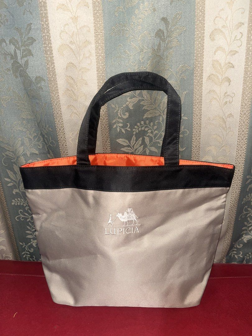 Beige Tote bag (Category: Tote Bags) located in Davao. Submitted by janna_soleil (Listing ID 1460622618, Image 1). Description: beige Lupicia tote bag featuring a contrasting bright orange interior lining.