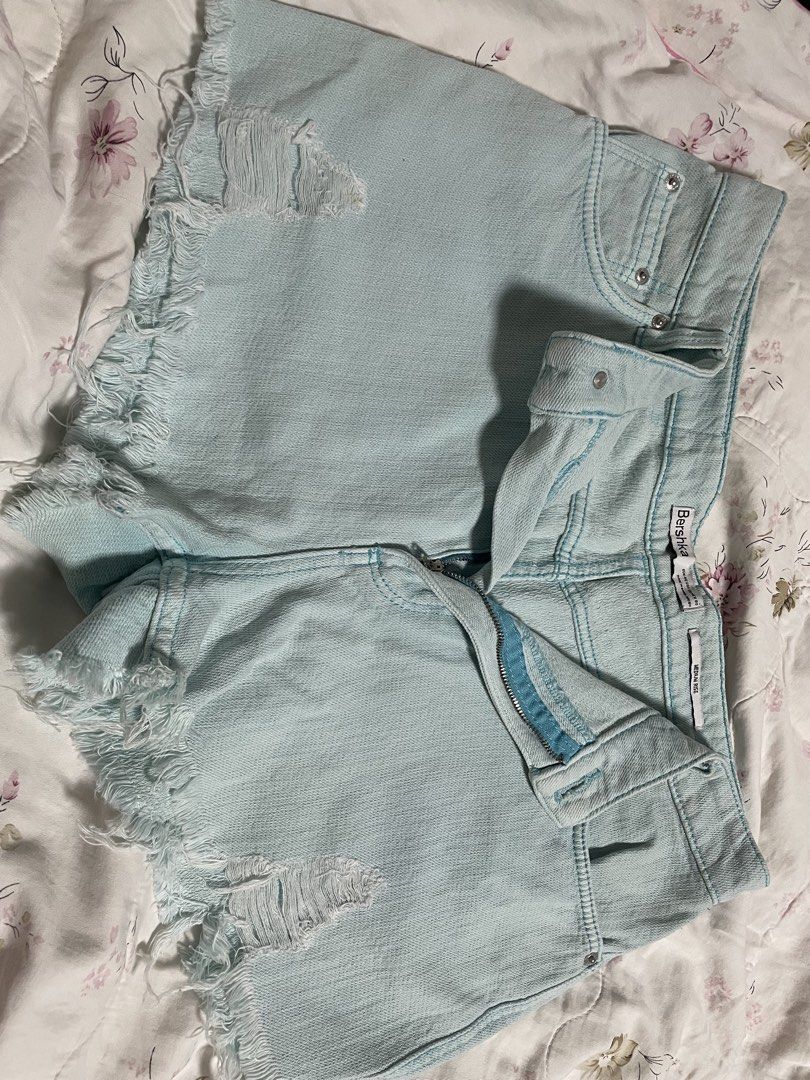 Bershka Light Blue Distressed Denim Shorts (Category: Shorts) located in Pasig City. Submitted by arabellesantamariaa (Listing ID 1460631056, Image 2). Description: - Brand: Bershka - Color: Light Blue Denim - Style: High-waisted shorts - Details: Distressed, frayed hem - Closure: Zipper and button - Fit: EU 40 - Occasion: Casual wear.