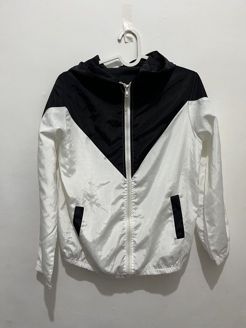 Black and White Hooded Windbreaker Jacket (Category: Coats, Jackets and Outerwear) located in Manila. Submitted by jonalainea95245 (Listing ID 1460708247, Image 1). Description: - Stylish black and white windbreaker jacket - Features a convenient hood and zipper closure - Two practical side pockets - Made with lightweight material for comfort - RFS: decluttering - Location: Malabon.