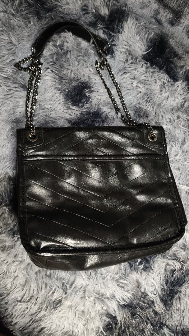 Black Chevron Quilted Chain Shoulder Bag (Category: Luxury Bags & Wallets) located in Manila. Submitted by serenitycarlylle (Listing ID 1460704243, Image 3). Description: - Black shoulder bag with elegant chevron quilting. - Features a chic chain strap for comfortable carrying. - Interior zippered pocket for secure storage. - Exterior flap closure with a convenient snap button. - Spacious interior to hold all your essentials. - Versatile design, 