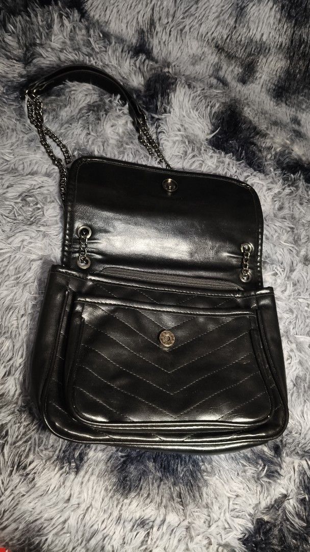 Black Chevron Quilted Chain Shoulder Bag (Category: Luxury Bags & Wallets) located in Manila. Submitted by serenitycarlylle (Listing ID 1460704243, Image 2). Description: - Black shoulder bag with elegant chevron quilting. - Features a chic chain strap for comfortable carrying. - Interior zippered pocket for secure storage. - Exterior flap closure with a convenient snap button. - Spacious interior to hold all your essentials. - Versatile design, 
