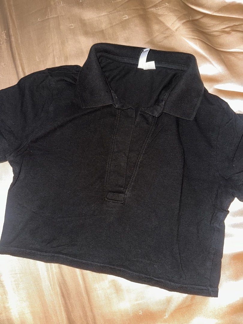 Black Cropped Polo Shirt (Category: Blouses) located in Manila. Submitted by _declutterwithmai (Listing ID 1460545274, Image 1). Description: - Classic black cropped polo shirt - Short sleeves and collar - Button-up placket - Easy to style for any occasion - Perfect for casual wear or dressing up.