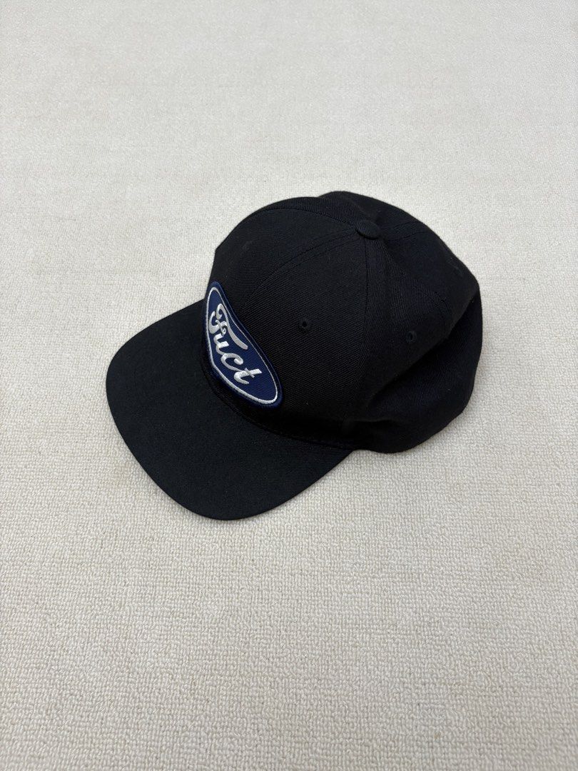 Black Ford "Fuct" Patch Baseball Cap (Category: Caps & Hats) located in Manila. Submitted by porma.market (Listing ID 1460518988, Image 3). Description: - Classic black baseball cap - Navy blue oval patch with white border - 'Fuct' logo in white lettering on patch - Made in the U.S.A. with imported material - Adjustable strap at the back for a custom fit - Perfect for casual wear.