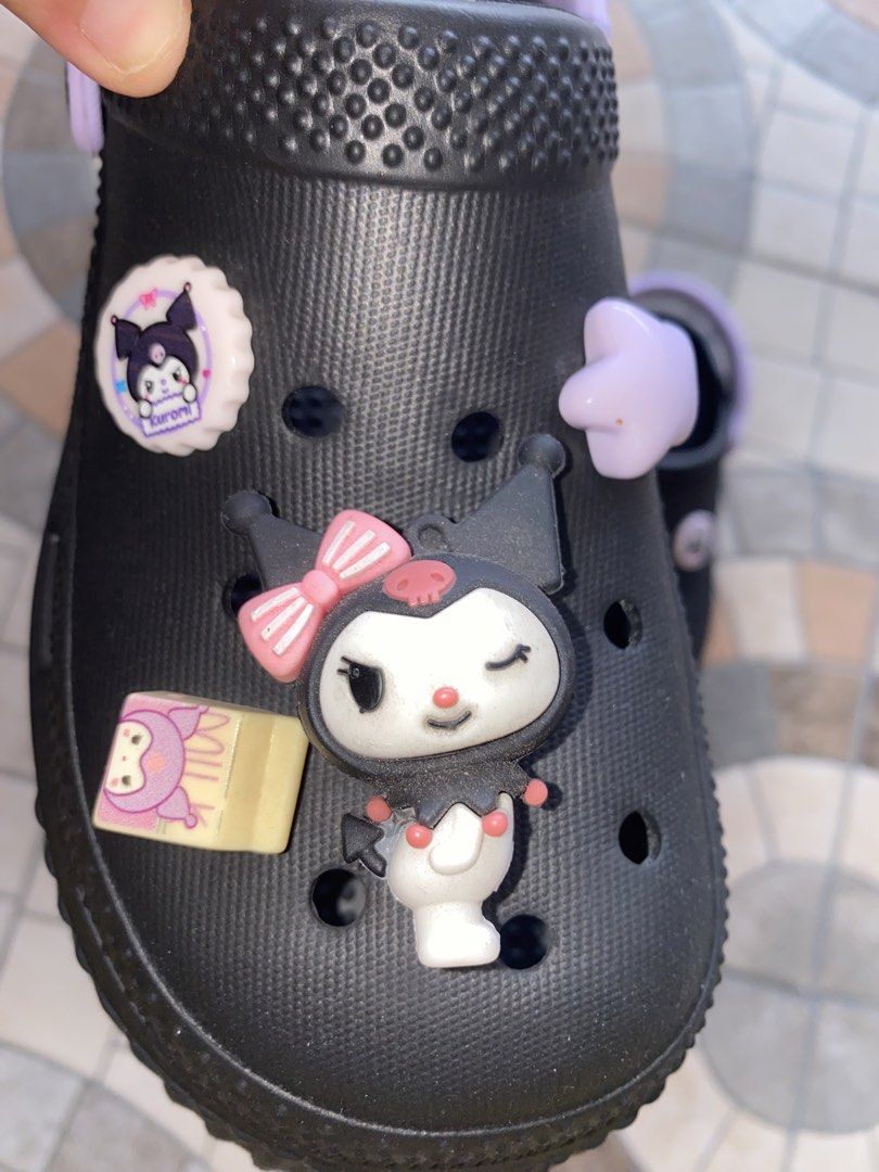 Black Kuromi Clogs with Charms Size 38 (Category: Slippers and slides) located in Pasay City. Submitted by violetttttttttttttt (Listing ID 1460579495, Image 2). Description: - Cute black clogs with adorable Kuromi charms - Features a light purple strap and sole accents - Wavy patterned sole for enhanced grip - Size 38 - Ideal for casual wear and lounging - Fun and playful design - Bought in Bangkok, Thailand.